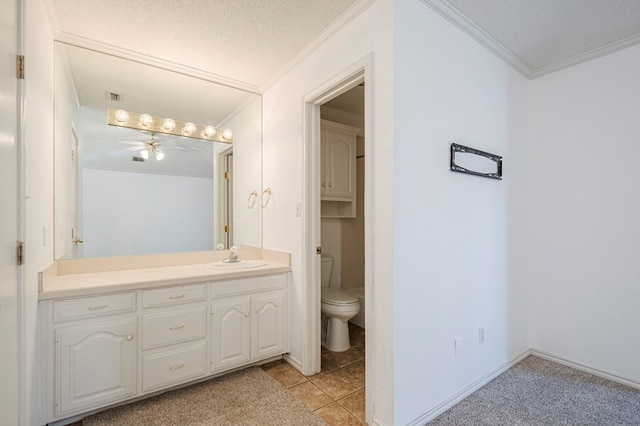 bathroom with visible vents, toilet, ornamental molding, vanity, and a textured ceiling