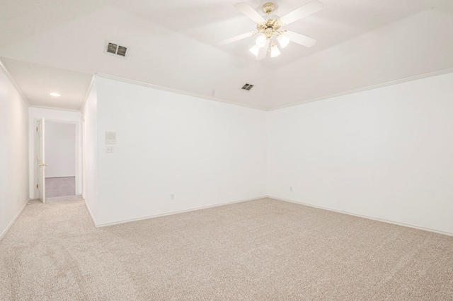 unfurnished room with crown molding, visible vents, a ceiling fan, light carpet, and vaulted ceiling