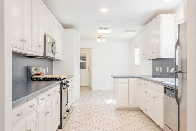 kitchen featuring white cabinets, stainless steel appliances, light countertops, and light tile patterned flooring