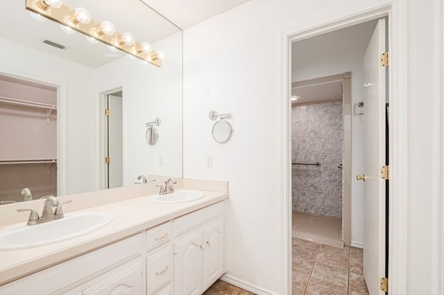 full bathroom with visible vents, a sink, and double vanity