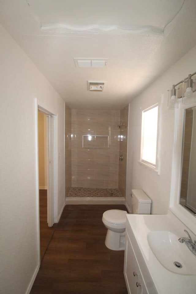 309 W Estes Ave, Midland, TX 79701 - bathroom featuring a tile shower, wood finished floors, and vanity