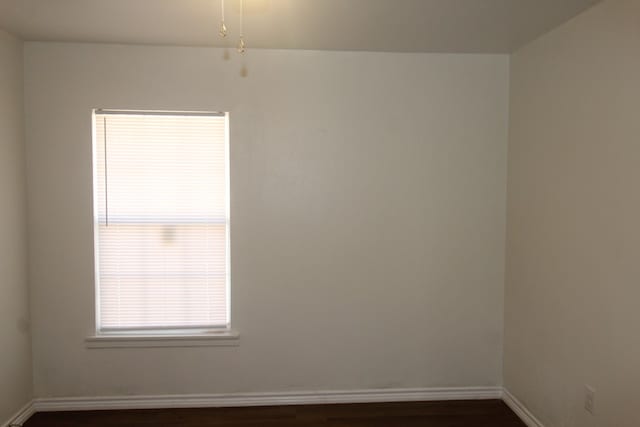 309 W Estes Ave, Midland, TX 79701 - spare room with dark wood-style flooring and baseboards