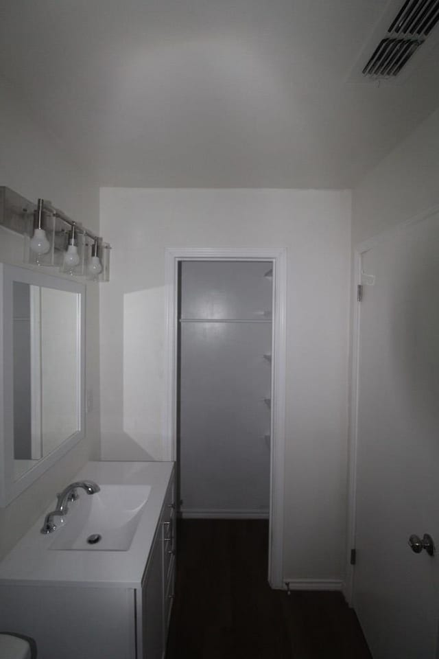 309 W Estes Ave, Midland, TX 79701 - bathroom featuring vanity and wood finished floors