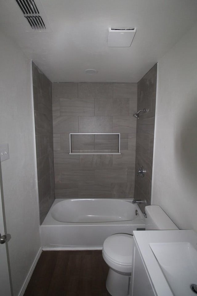 309 W Estes Ave, Midland, TX 79701 - full bathroom featuring washtub / shower combination, vanity, and wood finished floors