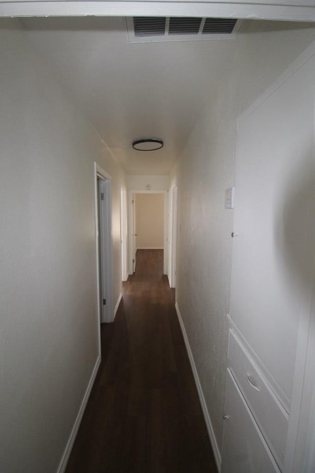 309 W Estes Ave, Midland, TX 79701 - hall featuring dark wood-style floors and baseboards