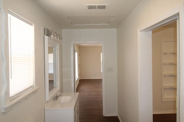 309 W Estes Ave, Midland, TX 79701 - hallway with a sink and dark wood-style flooring