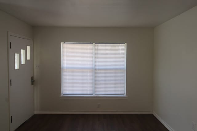 309 W Estes Ave, Midland, TX 79701 - spare room featuring dark wood-style floors and baseboards