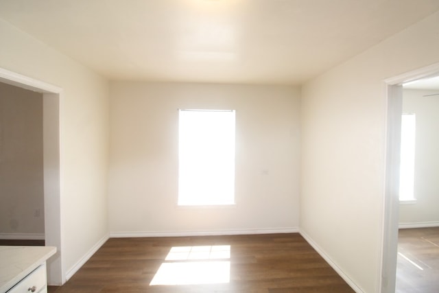 309 W Estes Ave, Midland, TX 79701 - spare room featuring plenty of natural light and dark wood-style flooring