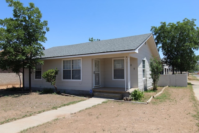 309 W Estes Ave, Midland, TX 79701 - view of front facade with roof with shingles and covered porch