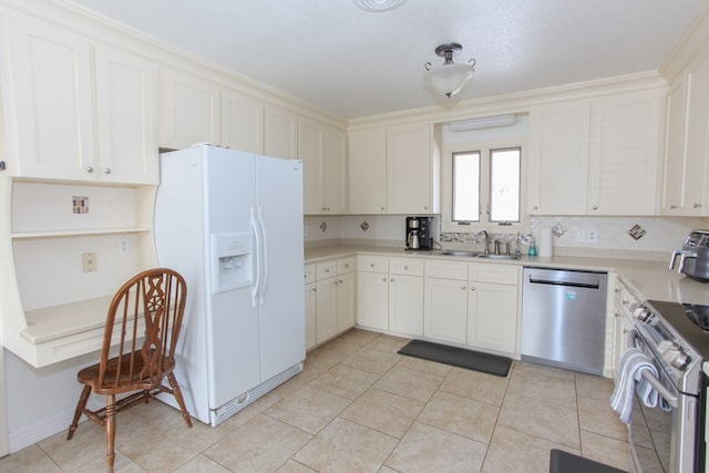 kitchen featuring white cabinets, sink, light tile patterned flooring, and appliances with stainless steel finishes