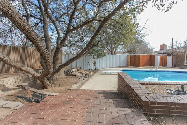 view of swimming pool featuring a diving board