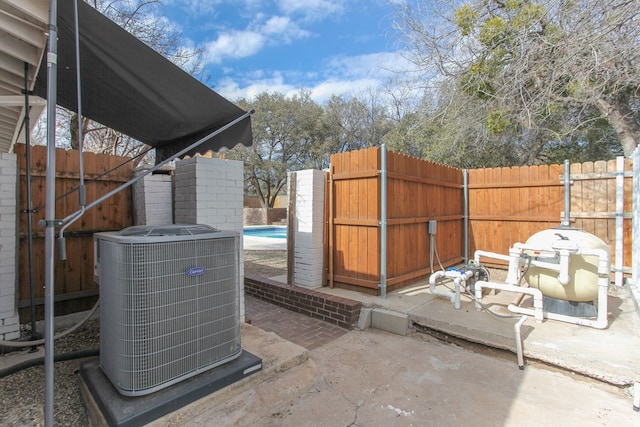 view of patio / terrace with a fenced in pool and central AC