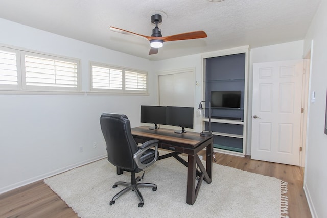 office featuring ceiling fan, wood-type flooring, and a textured ceiling