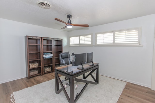 office area with wood-type flooring and ceiling fan