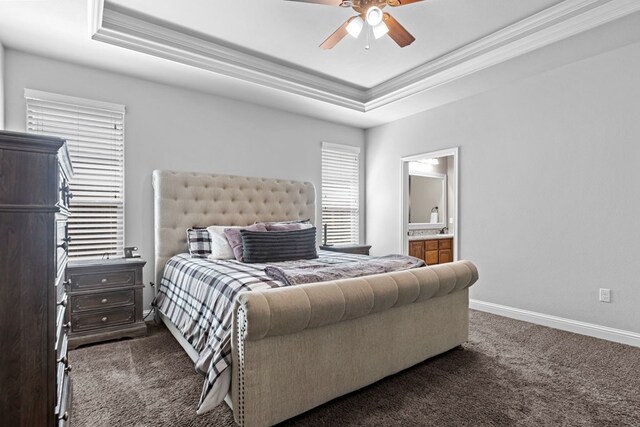 3101 Fairfield Ln, Midland, TX 79705 - bedroom featuring a raised ceiling, dark colored carpet, ornamental molding, baseboards, and connected bathroom