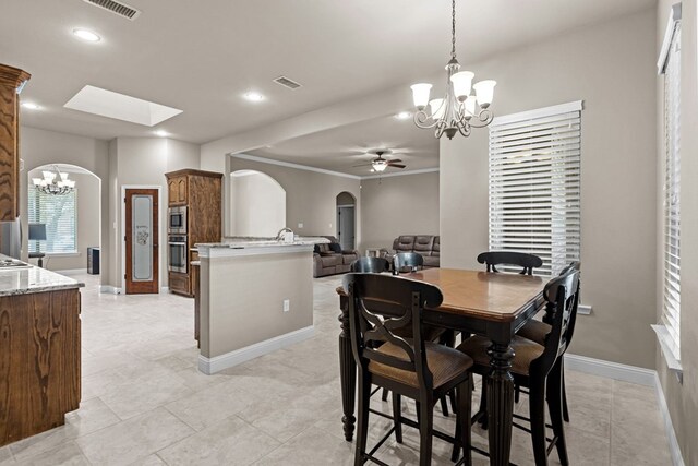 3101 Fairfield Ln, Midland, TX 79705 - dining space with a chandelier, arched walkways, a ceiling fan, baseboards, and recessed lighting