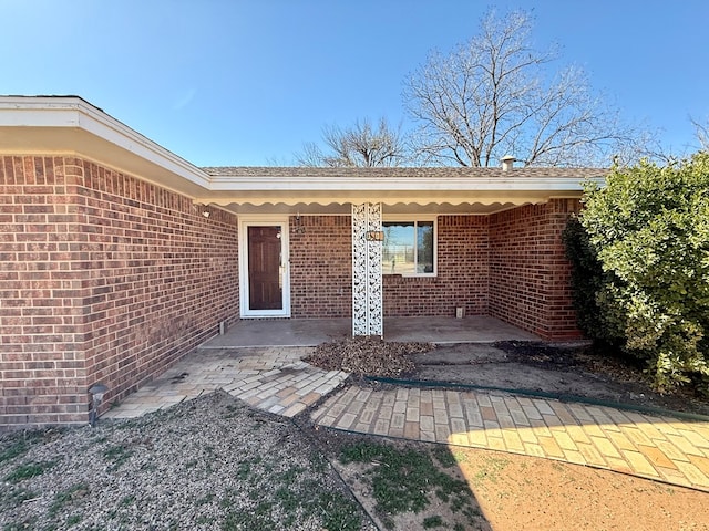 property entrance featuring a patio area