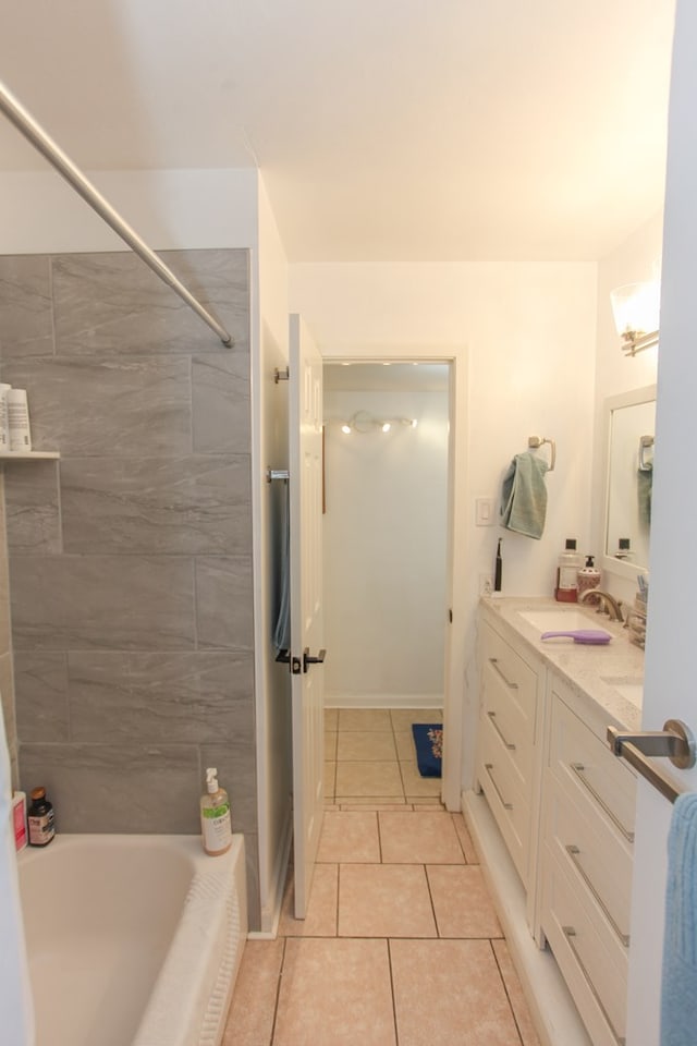 bathroom featuring tiled shower / bath, vanity, and tile patterned flooring