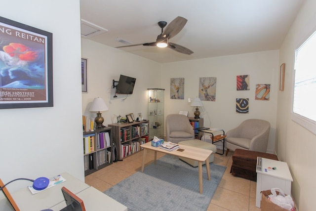 living room featuring light tile patterned floors and ceiling fan