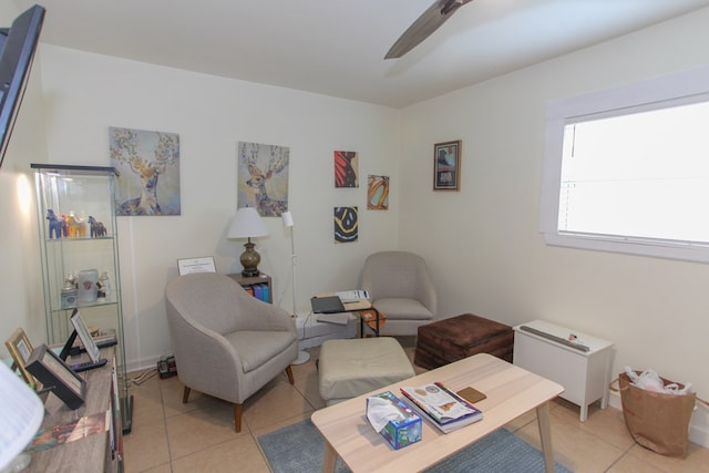 living area featuring ceiling fan and light tile patterned floors