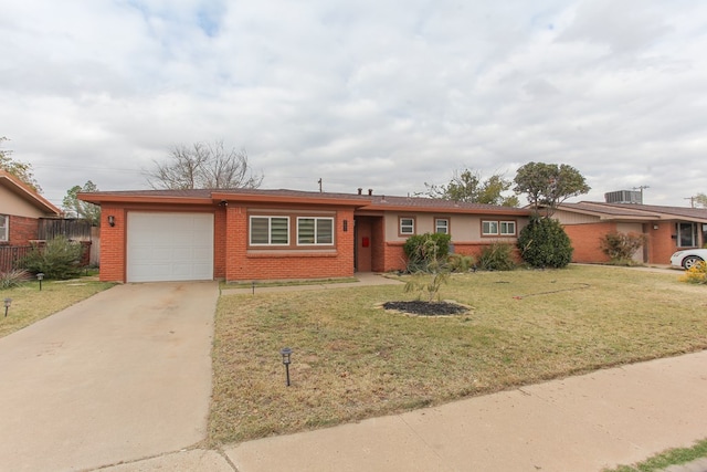 ranch-style home featuring brick siding, concrete driveway, an attached garage, cooling unit, and a front lawn