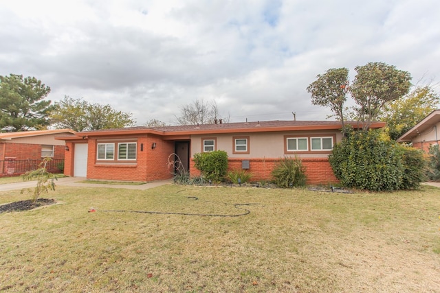 ranch-style home featuring concrete driveway, brick siding, a front lawn, and an attached garage