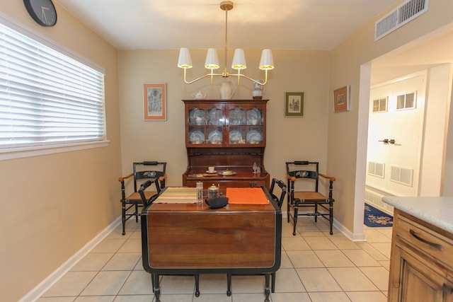 dining area with light tile patterned floors, visible vents, and baseboards