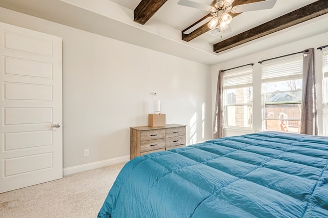 bedroom with beamed ceiling, carpet, and ceiling fan