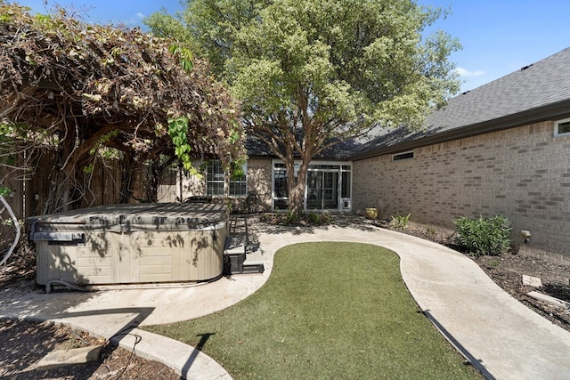 view of yard with a patio area and a hot tub