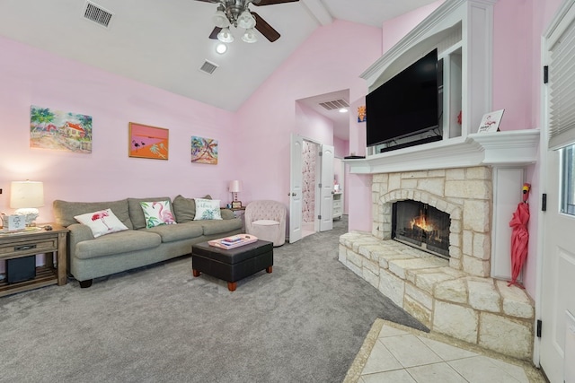 carpeted living room featuring beamed ceiling, high vaulted ceiling, a fireplace, and ceiling fan