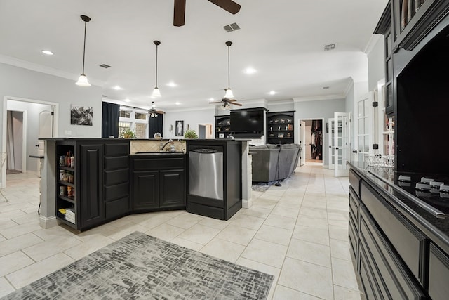 kitchen featuring a kitchen island with sink, crown molding, and light tile patterned flooring