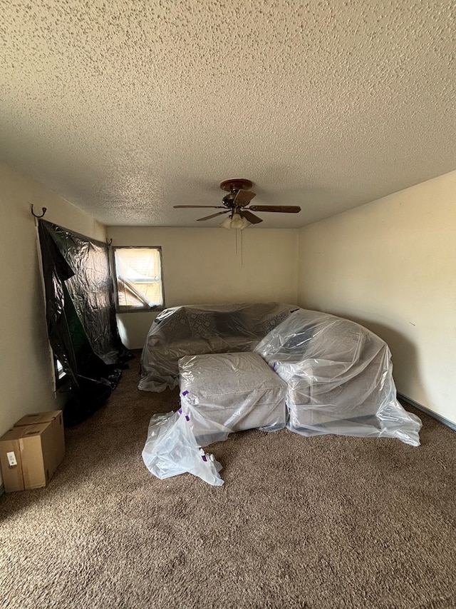 bedroom with a textured ceiling, ceiling fan, and carpet floors