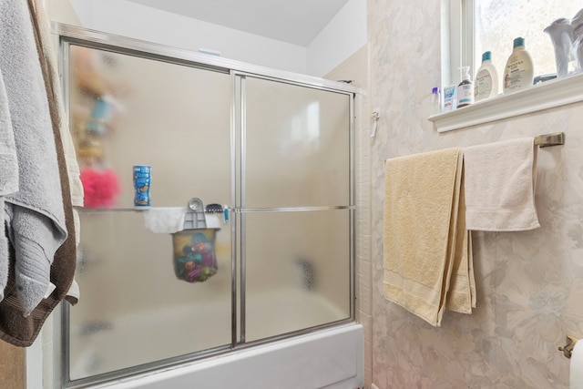full bath featuring shower / bath combination with glass door