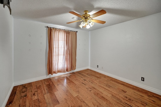 unfurnished room featuring ceiling fan, a textured ceiling, baseboards, and wood finished floors