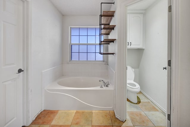 bathroom with toilet and a garden tub