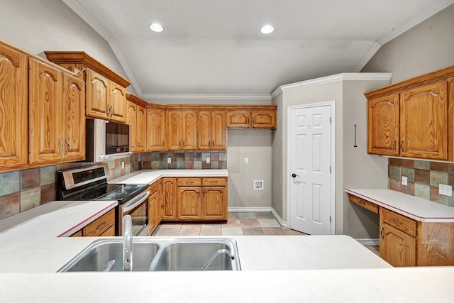 kitchen featuring ornamental molding, appliances with stainless steel finishes, brown cabinetry, and a sink