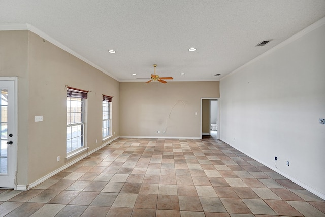 spare room with a textured ceiling, baseboards, visible vents, and crown molding