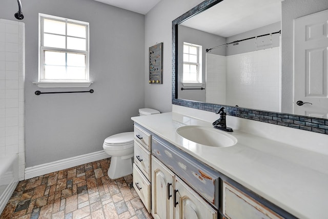 bathroom featuring toilet, brick floor, baseboards, and vanity