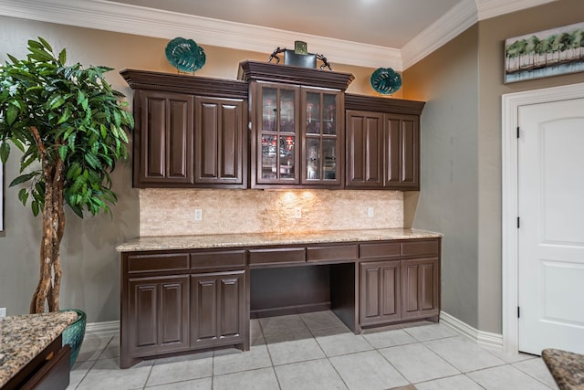 kitchen with tasteful backsplash, ornamental molding, and dark brown cabinetry