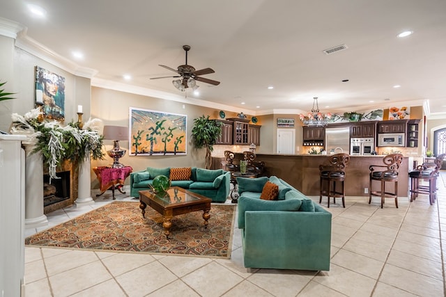 living room featuring light tile patterned floors, ornamental molding, decorative columns, and ceiling fan