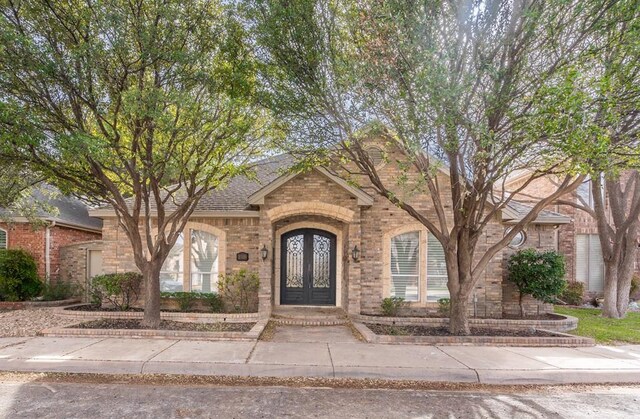 5705 Fenway Dr, Midland, TX 79707 - view of front facade featuring brick siding and french doors