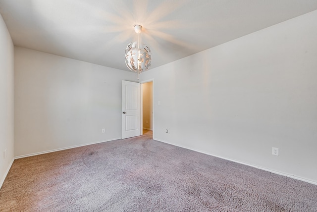 504 Wagner, Midland, TX 79706 - empty room with a chandelier, carpet, and baseboards