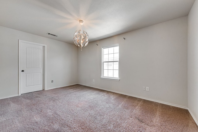504 Wagner, Midland, TX 79706 - empty room featuring carpet flooring, a chandelier, and baseboards