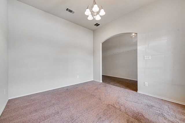 504 Wagner, Midland, TX 79706 - carpeted spare room with arched walkways, a chandelier, and baseboards