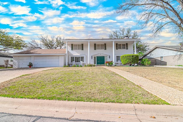 3108 Seaboard Ave, Midland, TX 79705 - neoclassical home with concrete driveway, a front lawn, an attached garage, and stucco siding