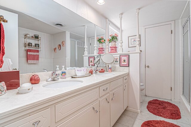 3108 Seaboard Ave, Midland, TX 79705 - full bathroom featuring a shower stall, double vanity, tile patterned floors, and toilet