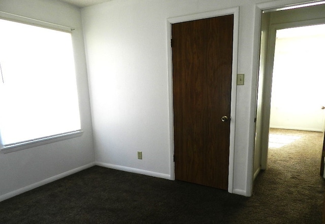 empty room with dark carpet