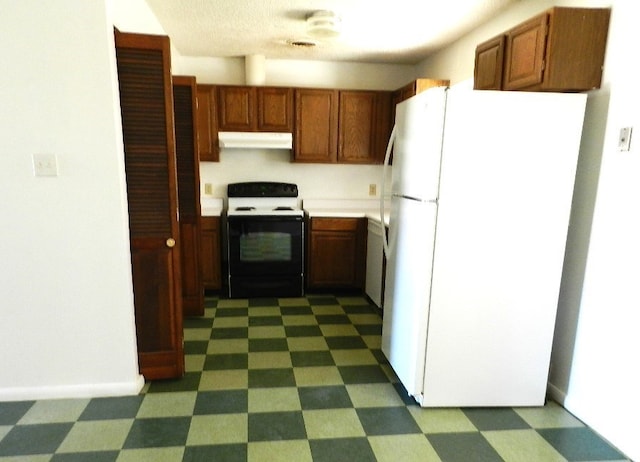 kitchen featuring white refrigerator and electric stove