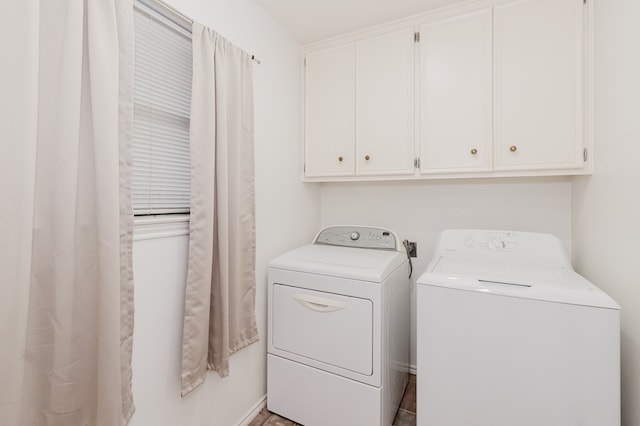 washroom with washer and dryer and cabinet space