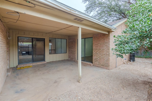 view of patio with a carport and visible vents